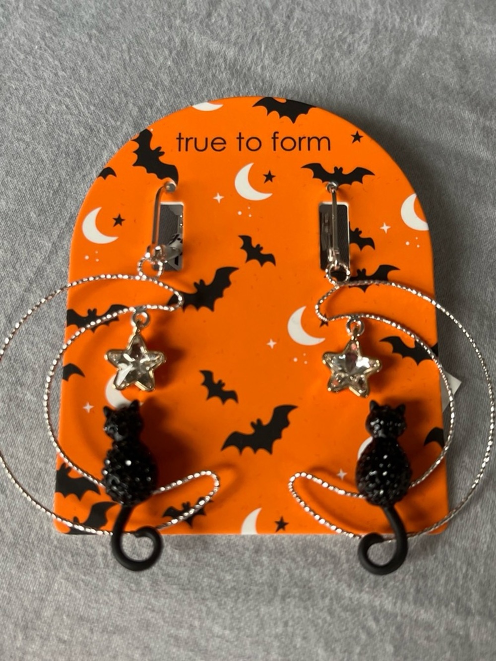True to Form black dangle cat earrings on moon with star charms